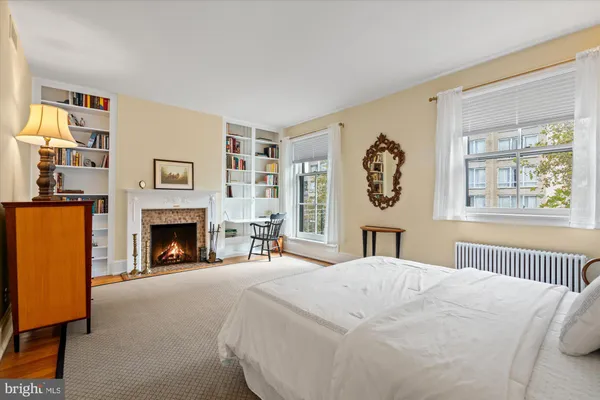 a bedroom with a bed and a fireplace