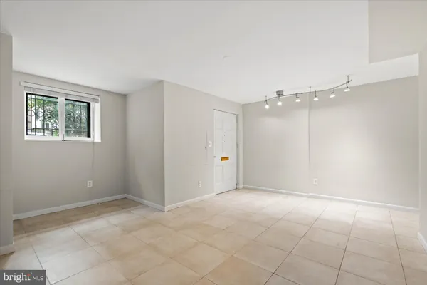 a kitchen with granite countertop stainless steel appliances and refrigerator