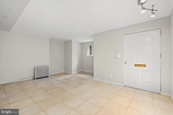 a bathroom with a bathtub shower sink vanity mirror and toilet