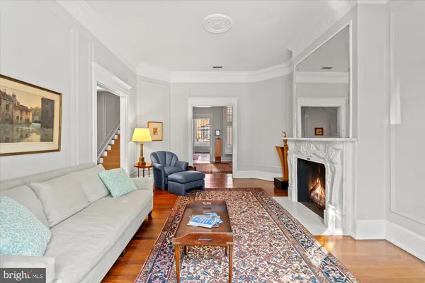 a living room with a fireplace furniture and a wooden floor