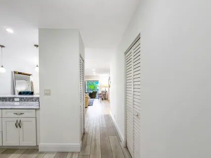 a view of hallway with livingroom and furniture