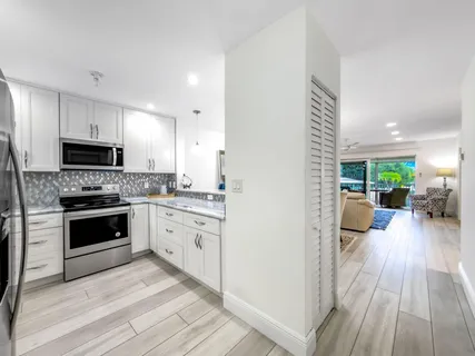 a kitchen with sink cabinets and wooden floor