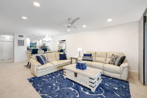 a living room with furniture a rug and a chandelier