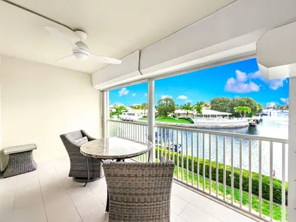 a view of a chairs and table in the balcony