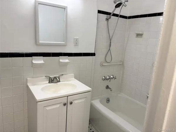 a bathroom with a sink a vanity and a shower