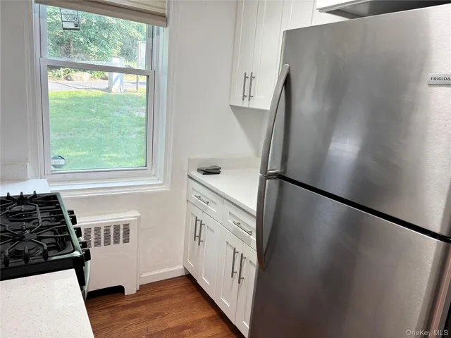 a kitchen with stainless steel appliances a refrigerator and a stove