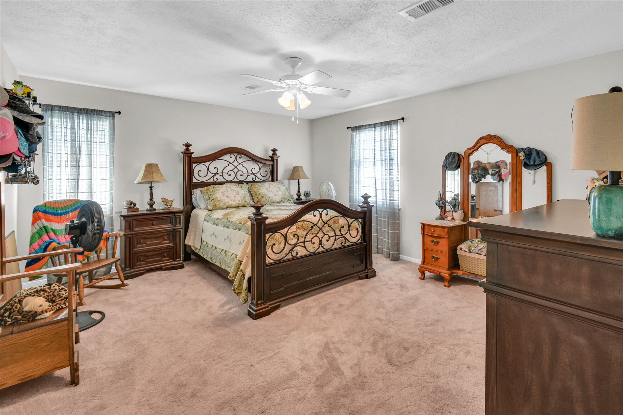 115 Driftwood Road Freeport, TX 77541 - Photo 15 of 21 a bedroom with a bed and a chandelier