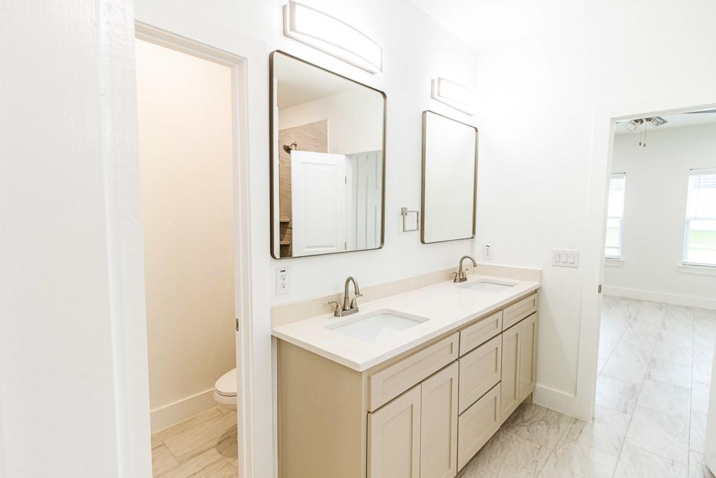 536 Highview Court Godley, TX 76044 - Photo 14 of 27 a bathroom with a sink and a mirror