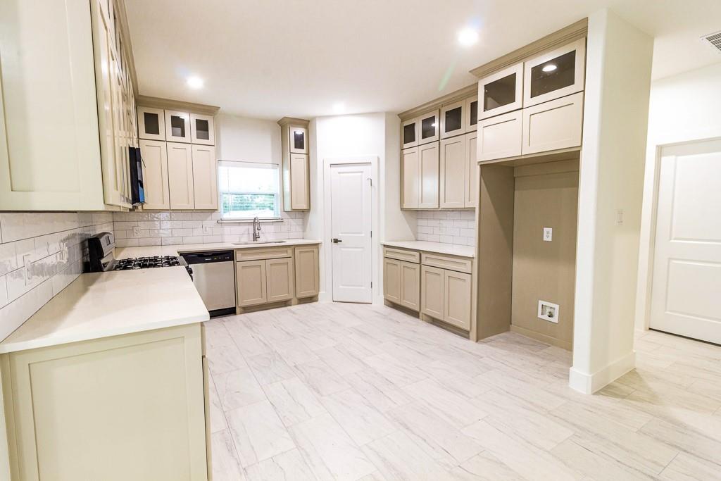 536 Highview Court Godley, TX 76044 - Photo 7 of 27 a kitchen with stainless steel appliances granite countertop a sink and cabinets