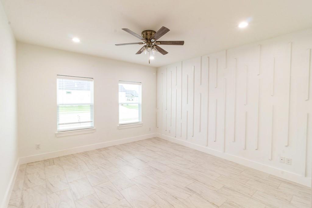 536 Highview Court Godley, TX 76044 - Photo 10 of 27 an empty room with windows and fan