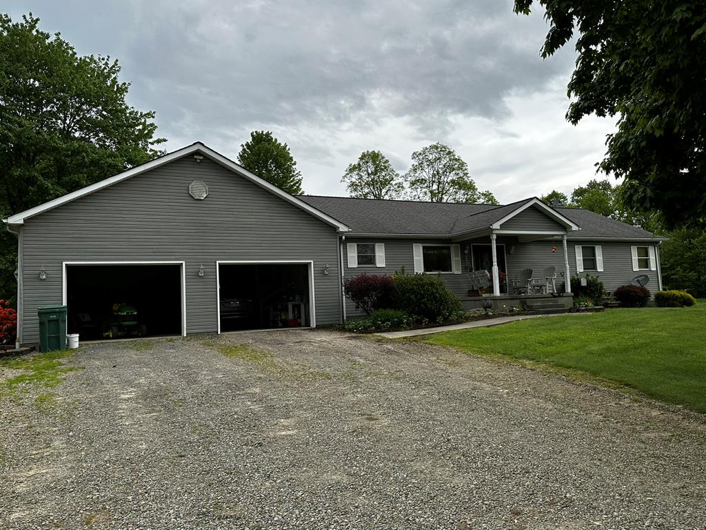 10716 County Line Road Greenville, PA 16125 - Photo 1 of 43 a front view of a house with a yard and garage
