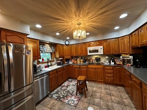 10716 County Line Road Greenville, PA 16125 - Photo 15 of 43 a kitchen with stainless steel appliances granite countertop a refrigerator a sink dishwasher a stove top oven a refrigerator and cabinets