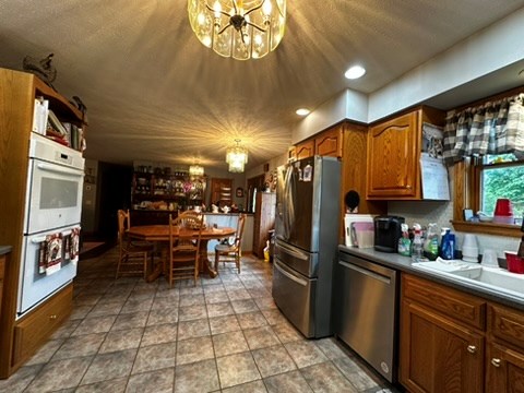 10716 County Line Road Greenville, PA 16125 - Photo 17 of 43 a kitchen with stainless steel appliances granite countertop a refrigerator and a stove top oven