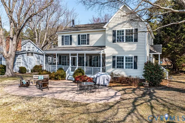 a view of a house with a yard patio and fire pit
