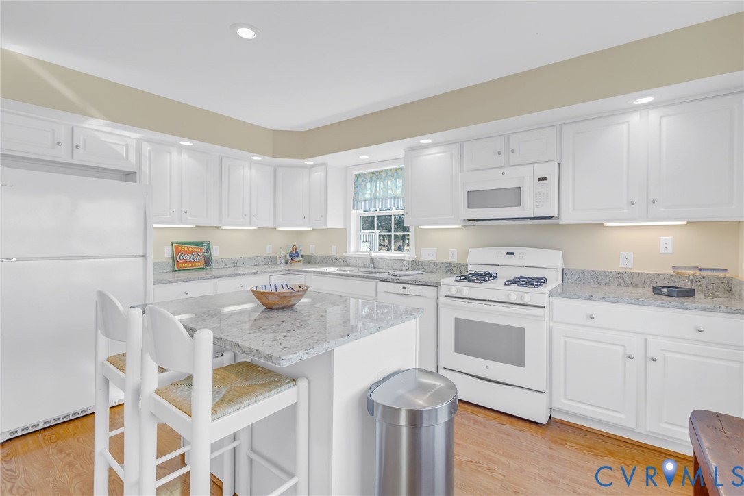 1159 Riverdale Road Warsaw, VA 22572 - Photo 11 of 42 a kitchen with granite countertop white cabinets and white appliances