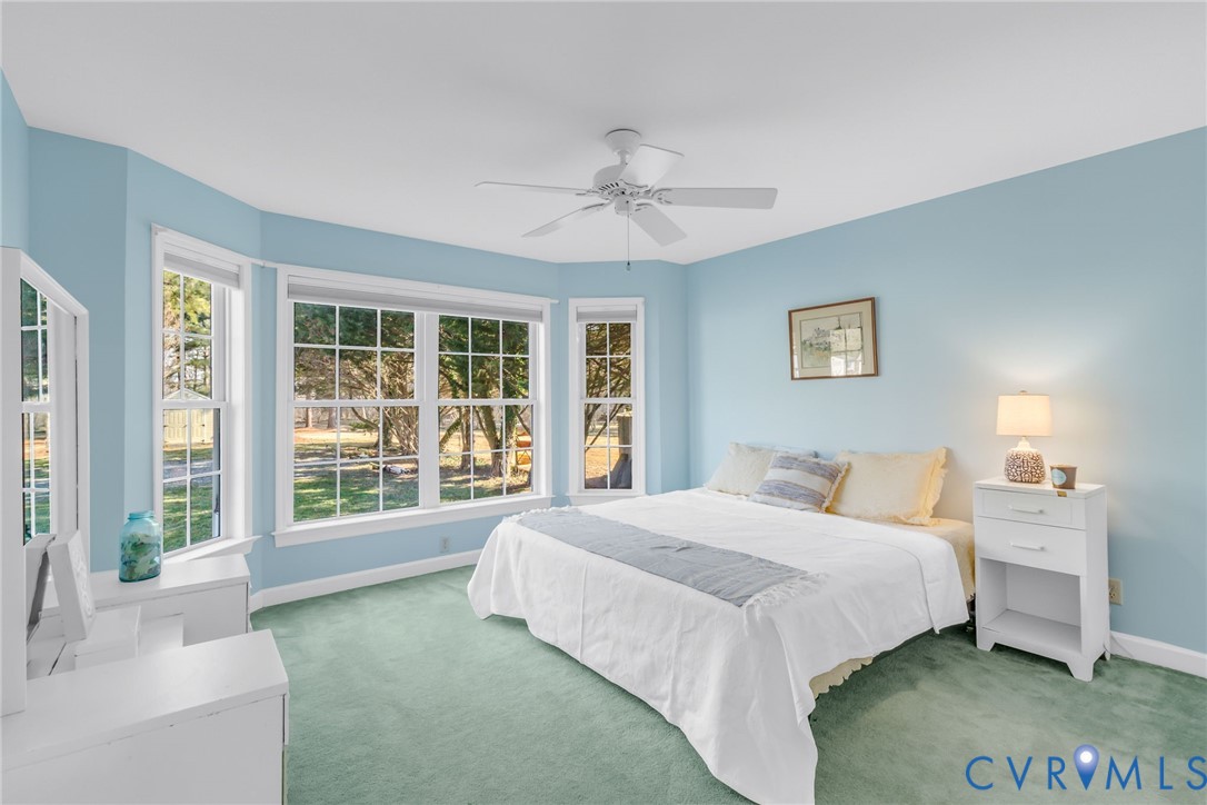 1159 Riverdale Road Warsaw, VA 22572 - Photo 14 of 42 a bedroom with a large bed and a large window