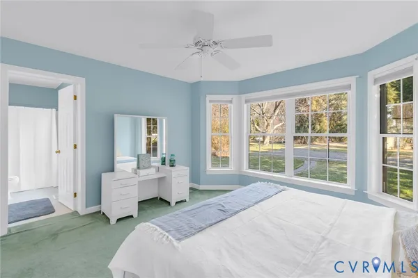 a spacious bedroom with a bed and a large window