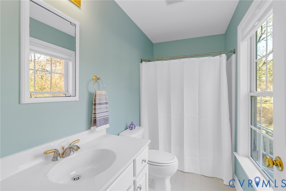 1159 Riverdale Road Warsaw, VA 22572 - Photo 16 of 42 a bathroom with a sink toilet and tub