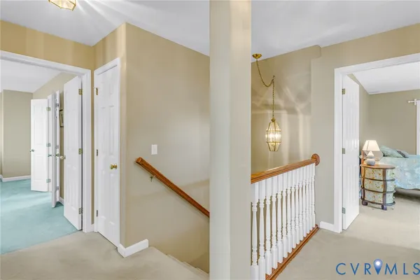 a view of a hallway with a livingroom and entryway