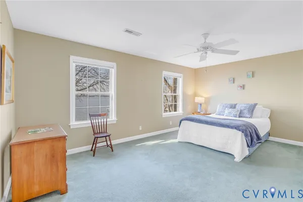 a spacious bedroom with a bed and a window