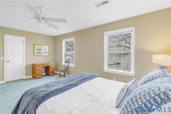 a bedroom with a large bed and a window