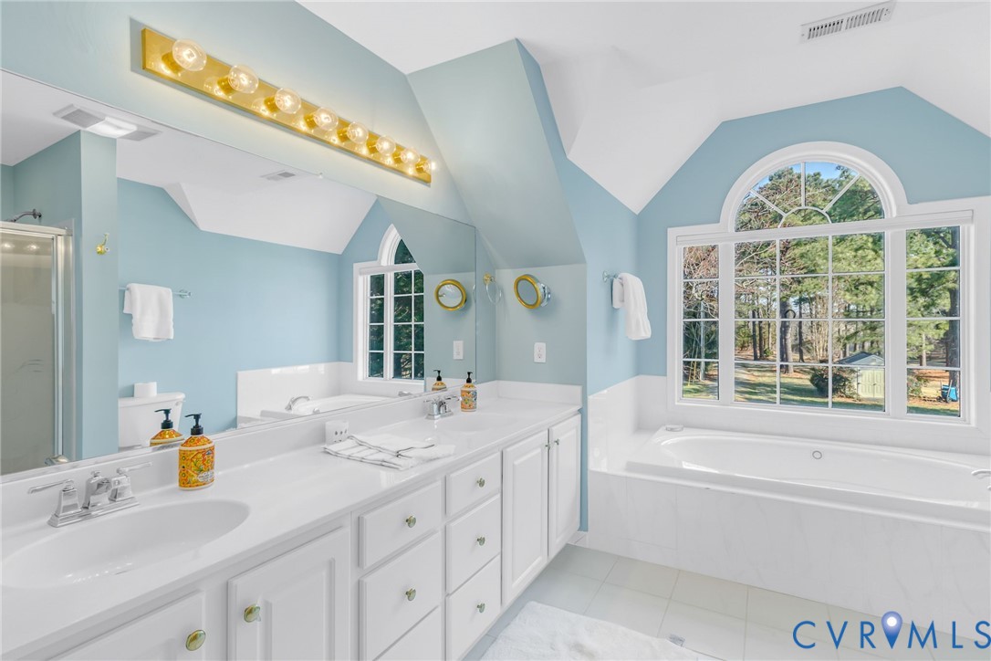1159 Riverdale Road Warsaw, VA 22572 - Photo 25 of 42 a spacious bathroom with a tub sink and mirror
