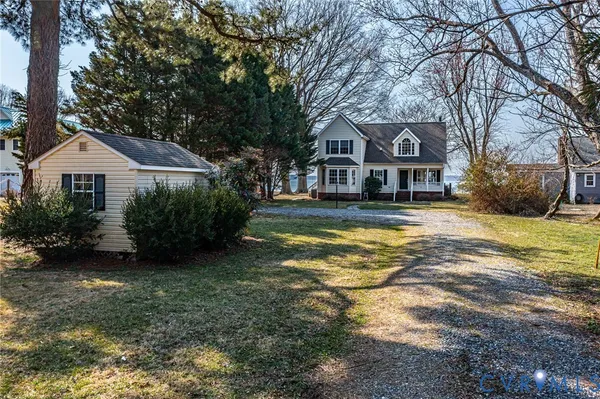a front view of a house with yard and green space