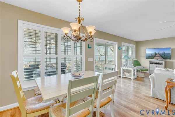 a view of a dining room with furniture wooden floor and chandelier
