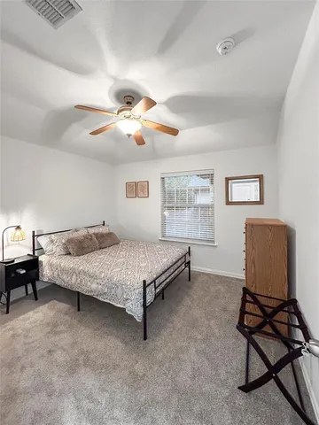 a bedroom with a bed chair and window