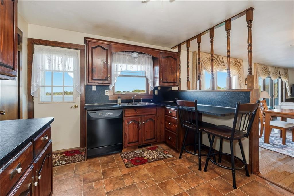 127 East Buffalo Church Road Washington, PA 15301 - Photo 13 of 33 a kitchen with granite countertop a stove a sink and a refrigerator
