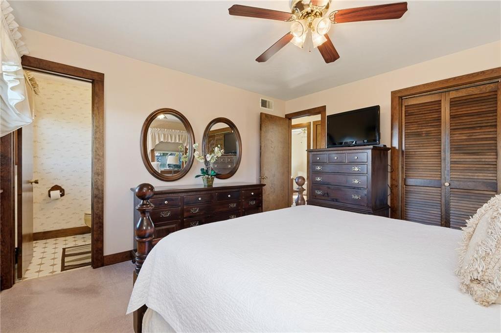 127 East Buffalo Church Road Washington, PA 15301 - Photo 17 of 33 a bedroom with a bed and a chandelier