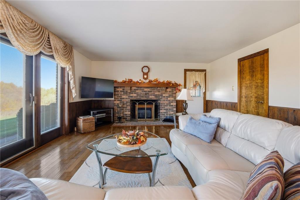 127 East Buffalo Church Road Washington, PA 15301 - Photo 7 of 33 a living room with furniture a fireplace and a flat screen tv