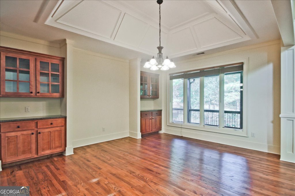 194 Edgewater Trail South Toccoa, GA 30577 - Photo 12 of 70 a view of an empty room with wooden floor and a window