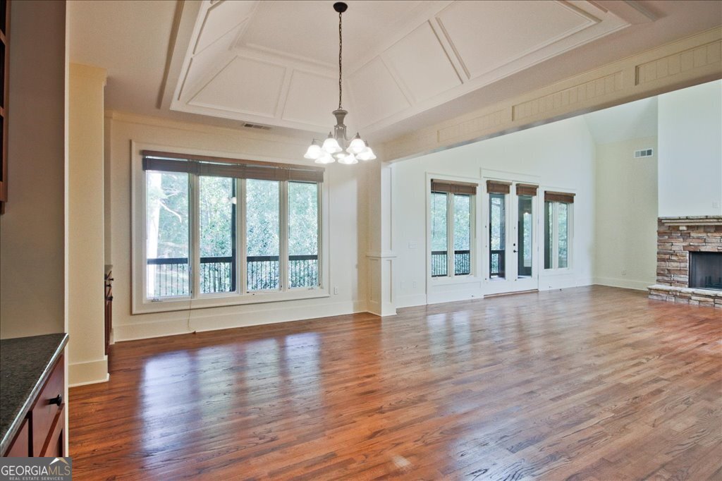 194 Edgewater Trail South Toccoa, GA 30577 - Photo 13 of 70 a view of an empty room with wooden floor and a window