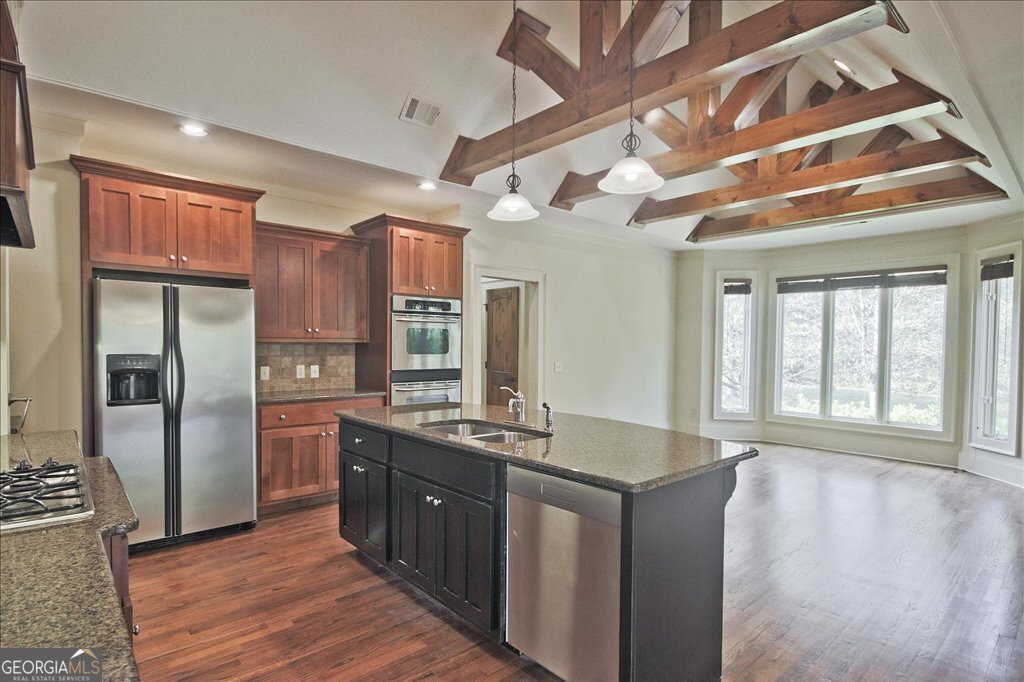 194 Edgewater Trail South Toccoa, GA 30577 - Photo 19 of 70 a kitchen with stainless steel appliances granite countertop a sink a stove and a refrigerator