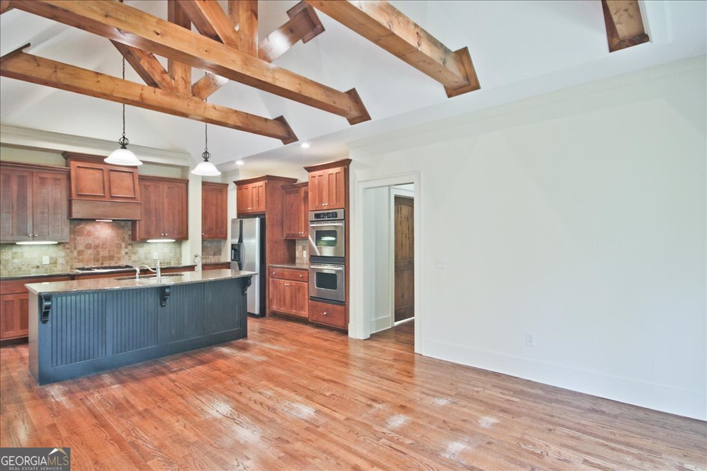 194 Edgewater Trail South Toccoa, GA 30577 - Photo 21 of 70 a large kitchen with lots of counter space and wooden floor