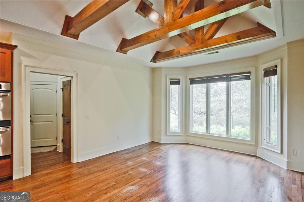 194 Edgewater Trail South Toccoa, GA 30577 - Photo 22 of 70 a view of an empty room with wooden floor and a window