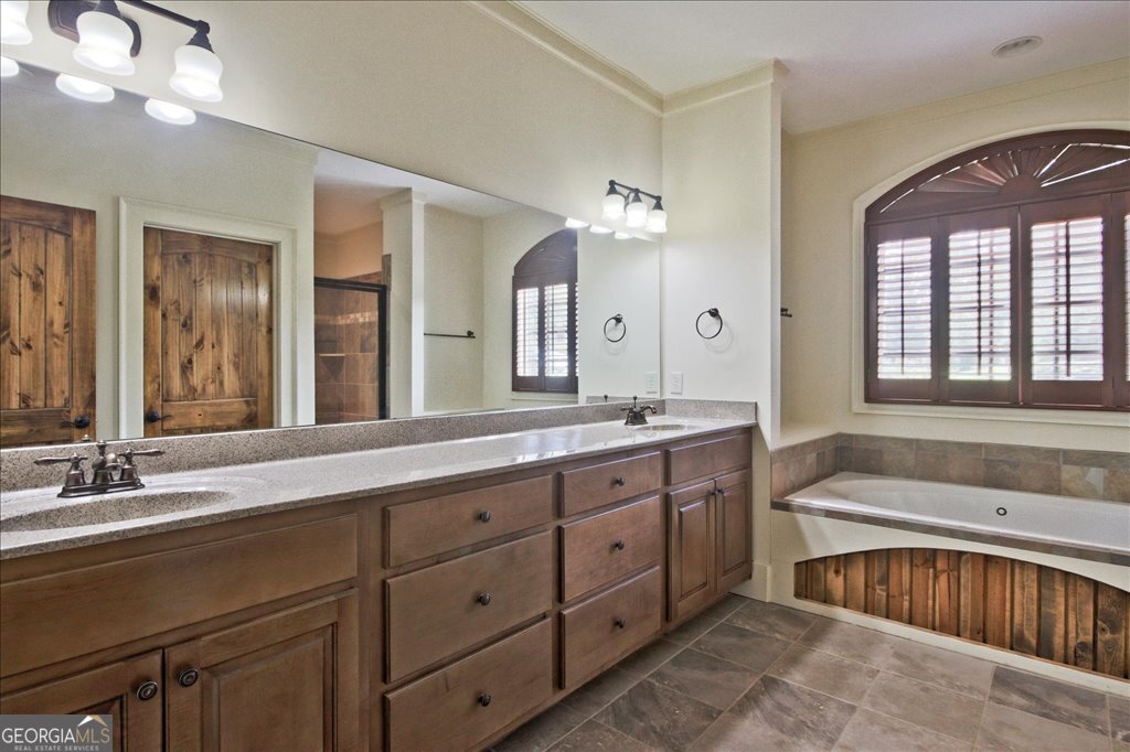 194 Edgewater Trail South Toccoa, GA 30577 - Photo 26 of 70 a spacious bathroom with a double vanity sink double mirror and bathtub