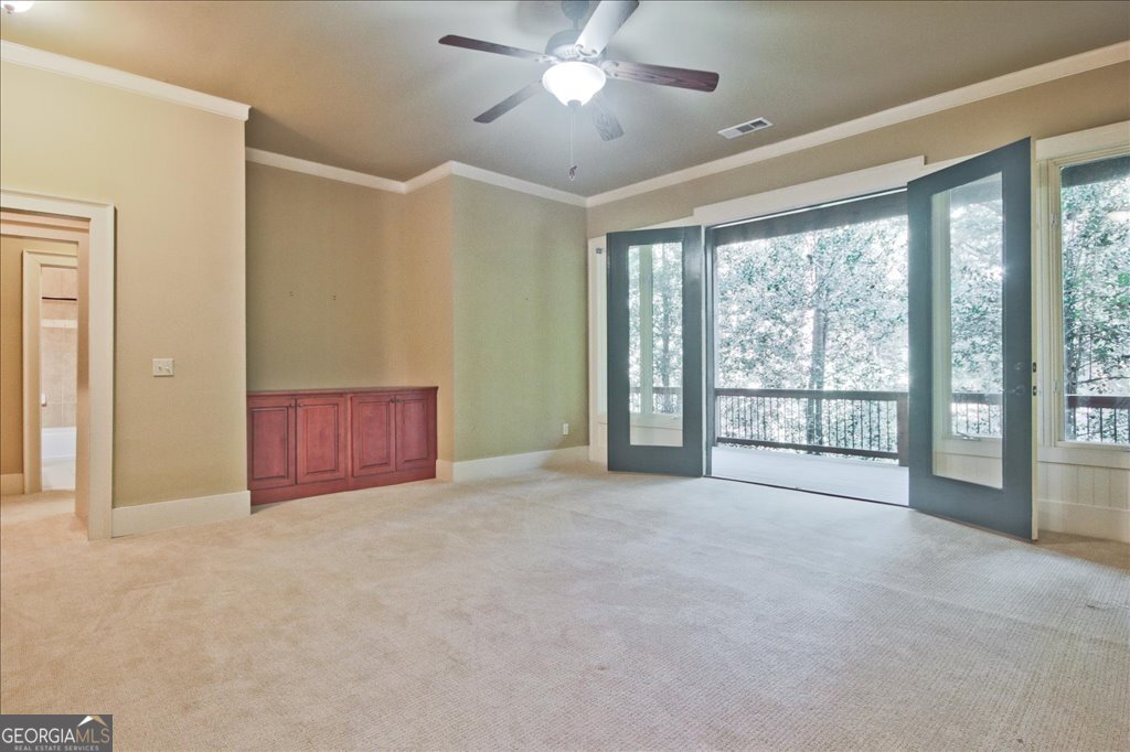 194 Edgewater Trail South Toccoa, GA 30577 - Photo 34 of 70 a view of an empty room with window and chandelier fan