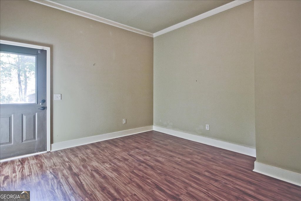 194 Edgewater Trail South Toccoa, GA 30577 - Photo 43 of 70 a view of an empty room with wooden floor and a window