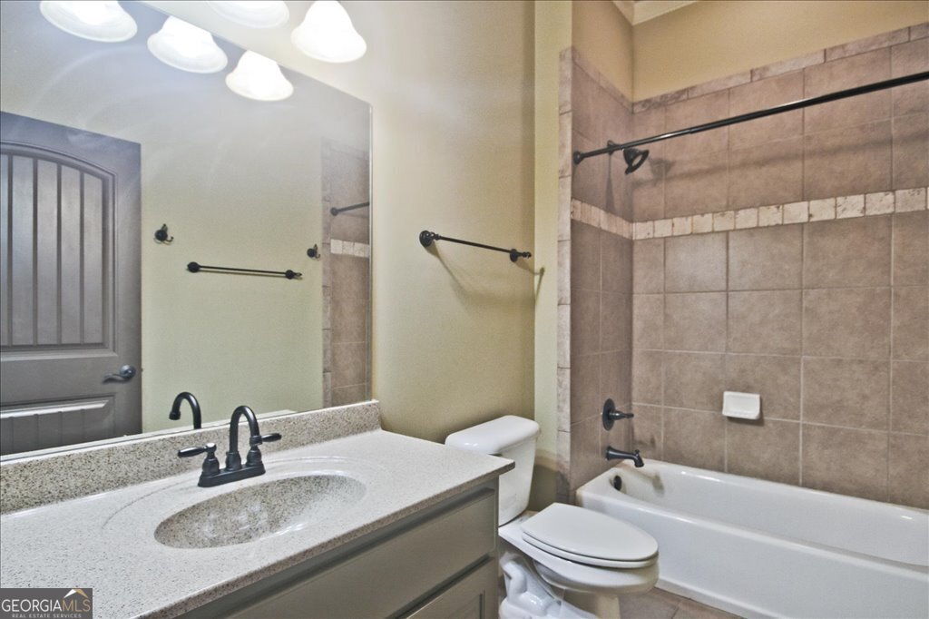 194 Edgewater Trail South Toccoa, GA 30577 - Photo 44 of 70 a bathroom with a granite countertop sink toilet mirror and shower