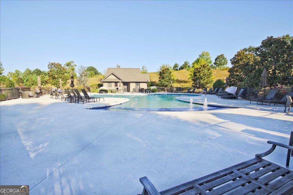 194 Edgewater Trail South Toccoa, GA 30577 - Photo 67 of 70 a view of a swimming pool with an outdoor seating and a garden