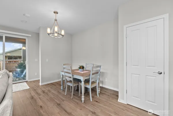 a view of a dining room with furniture wooden floor and chandelier