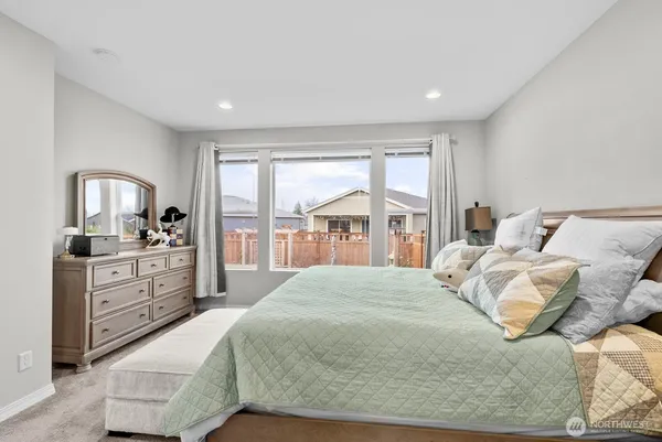 a spacious bedroom with a large bed and a window