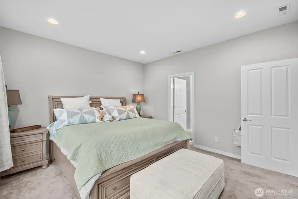 a bedroom with a large bed and a chandelier