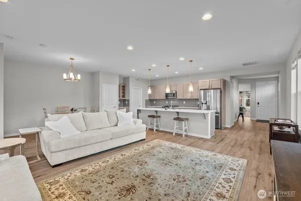 a living room with furniture and view of kitchen