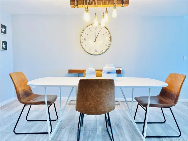 a dining room with furniture and a floor to ceiling window