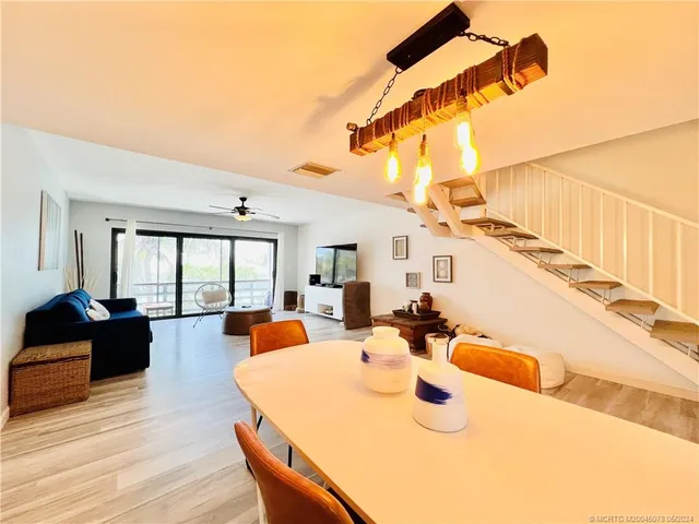 a dining room with a wooden table and chairs