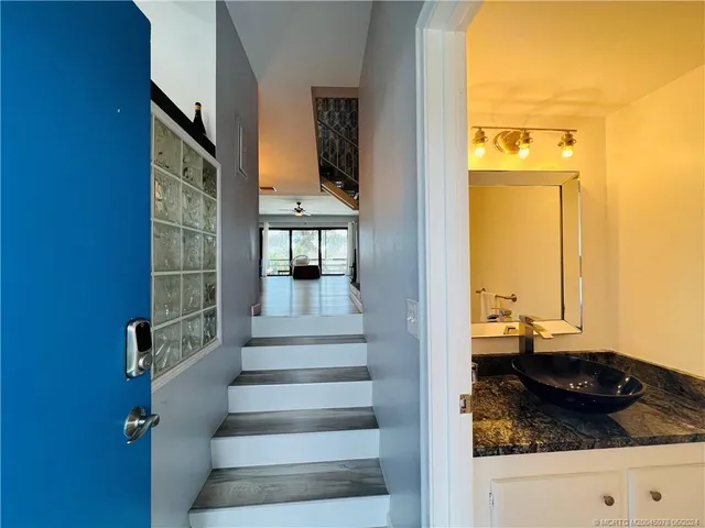 a view of a hallway with wooden floor and a fireplace