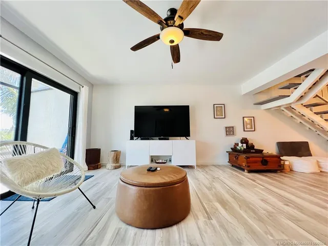 a living room with a flat screen tv and a floor to ceiling window